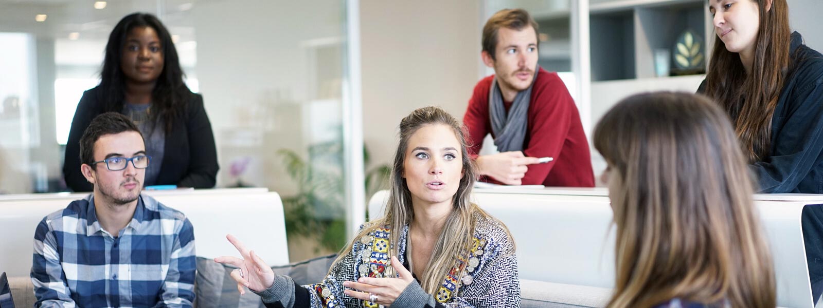Two colleagues discussing work in a bright office.